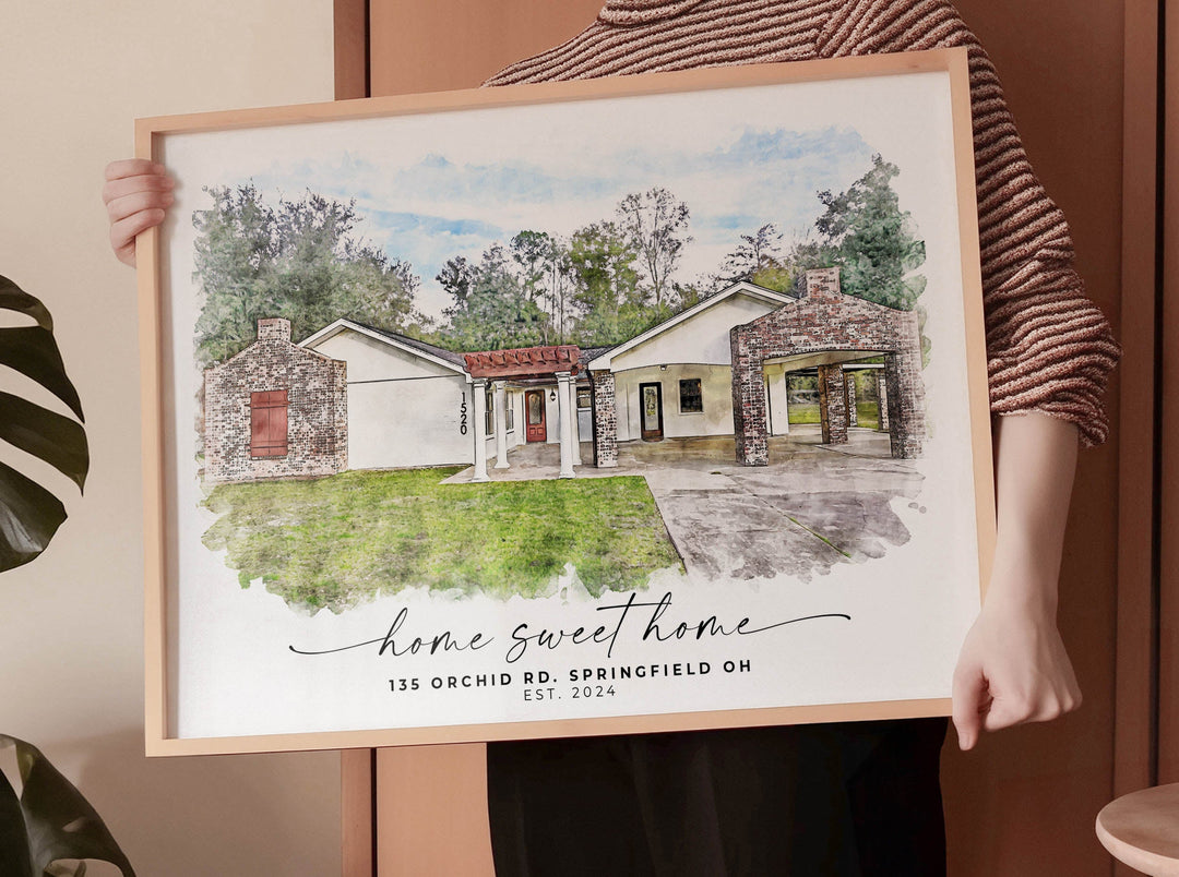 A custom house portrait framed on a modern entryway table, symbolizing a thoughtful real estate closing gift