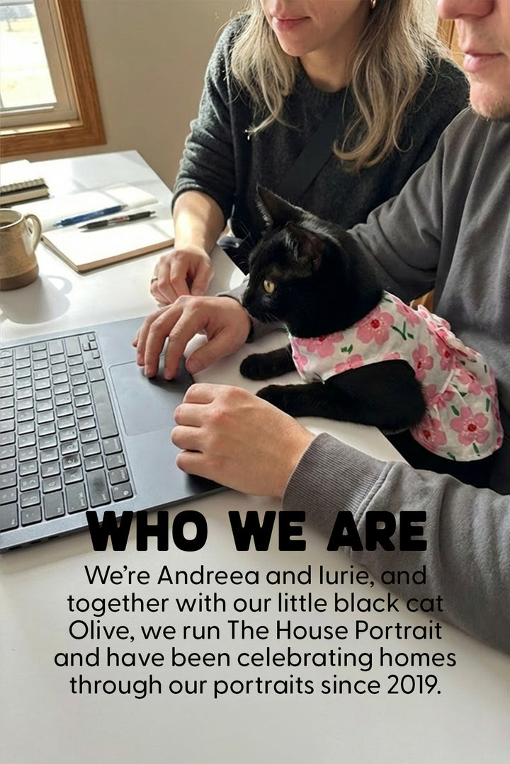 A black cat wearing a pink floral shirt sits on a table while a woman and man use a laptop. Large overlaid text reads 'WHO WE ARE' and describes Andreea and Lurie running The House Portrait with Olive, a black cat, since 2019.