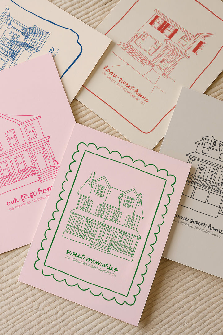 A set of illustrated house-themed cards or prints arranged on a textured cream fabric background. The visible designs include pink, red, blue, and black line drawings of houses with phrases such as "our first home," "home sweet home," and "sweet memories.